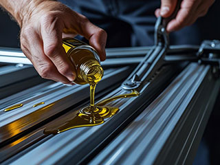 Technician performing routine garage door maintenance and spring testing in Goodyear, AZ garage