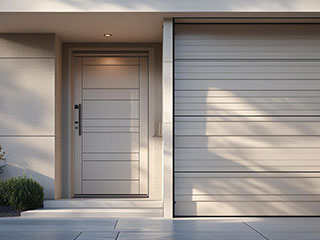 Technician inspecting and servicing a garage door under regular use in Goodyear, AZ