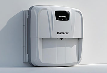 Technician installing a smart garage door opener in a clean Goodyear, AZ home garage
