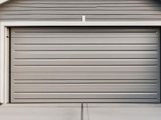 Technician replacing a modern residential garage door for a satisfied homeowner in Goodyear, AZ