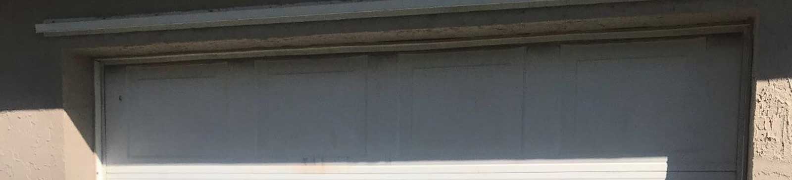 White sectional garage door showing smooth surface and tight weather-seal after check-up in Goodyear AZ