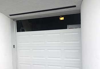 Sectional steel garage door being professionally fitted at Avondale Arizona residence