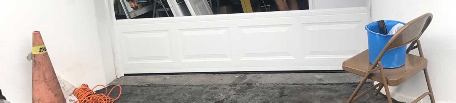 Sectional steel garage door being professionally fitted at Avondale Arizona residence